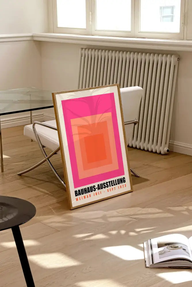 A framed bauhaus geometric canvas print with concentric pink and orange squares for home decor by decorbites