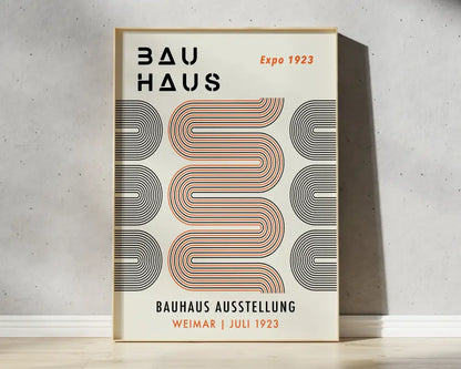 A minimalist bauhaus geometric canvas print with bold black and orange patterns on cream for home decor framed in light wood