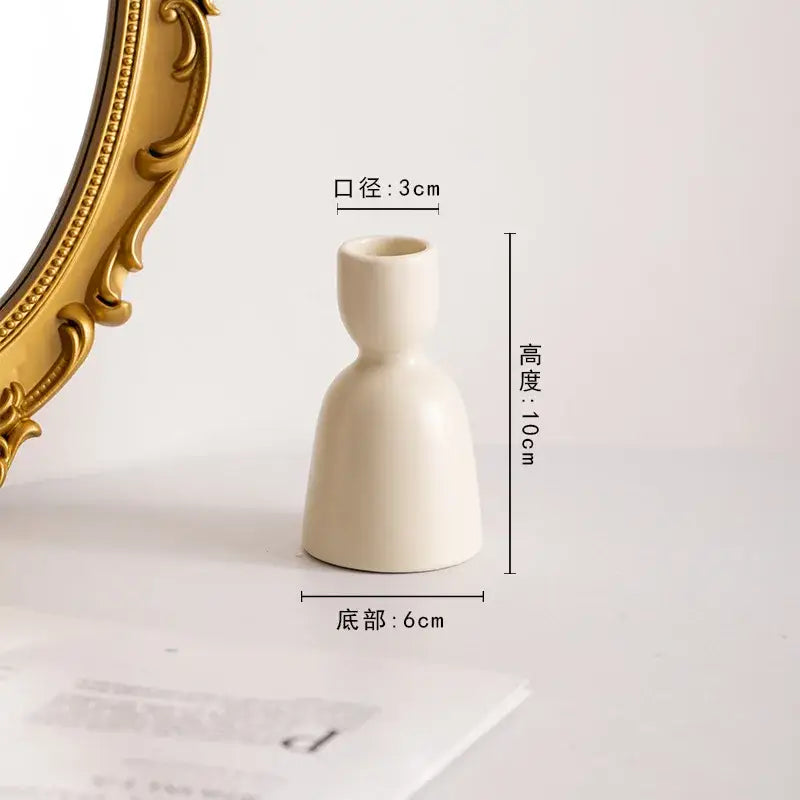 Cream-colored ceramic candle holder with slender neck and flared base for decorbites geometric ceramic candle set