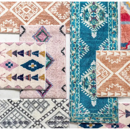 A collection of colorful decorbites boho runner rugs with geometric and tribal patterns in teal peach pink and gray