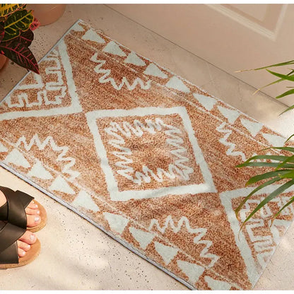 A plush tan and white geometric-patterned decorbites boho runner bath mat with a soft textured surface for entryways