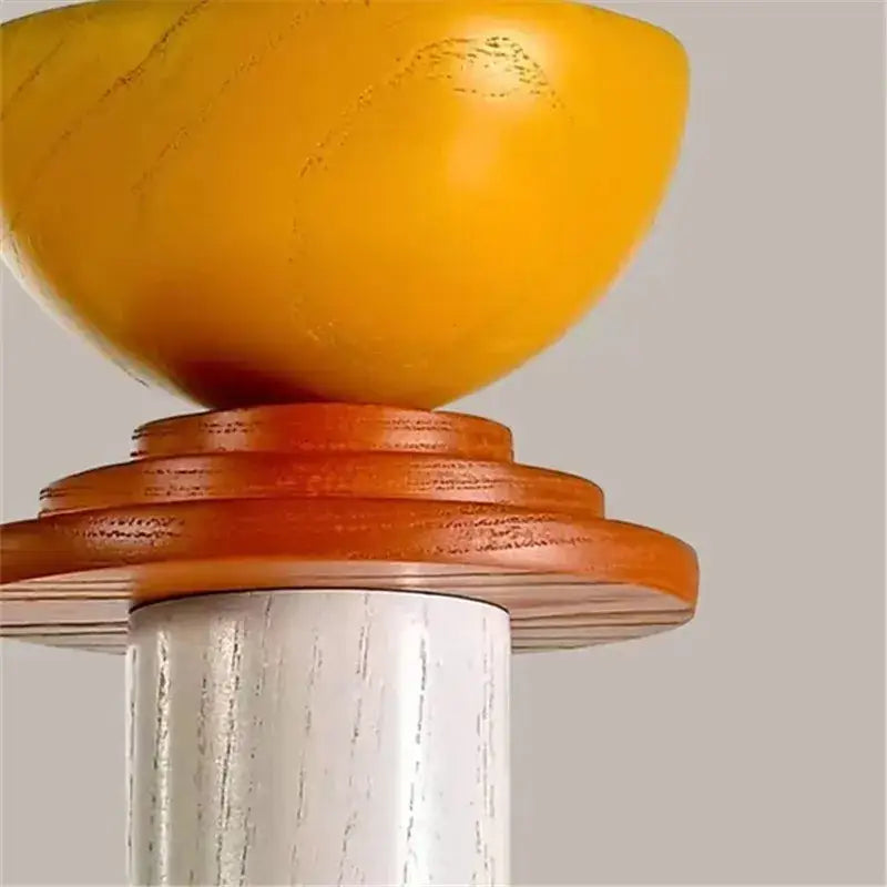 A vibrant yellow hand-carved wooden bowl on warm-toned wood rings mounted on white-washed post for led wooden pendant light decorbites
