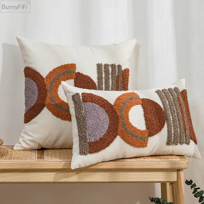 Cream-colored rectangular cushion cover with rust orange gray and beige geometric embroidered pattern for home decor