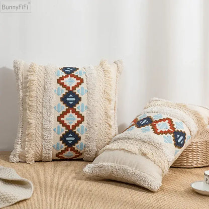 Cream-colored cushion cover with frayed edges and blue red geometric embroidered pattern for home decor by decorbites geometric embroidered