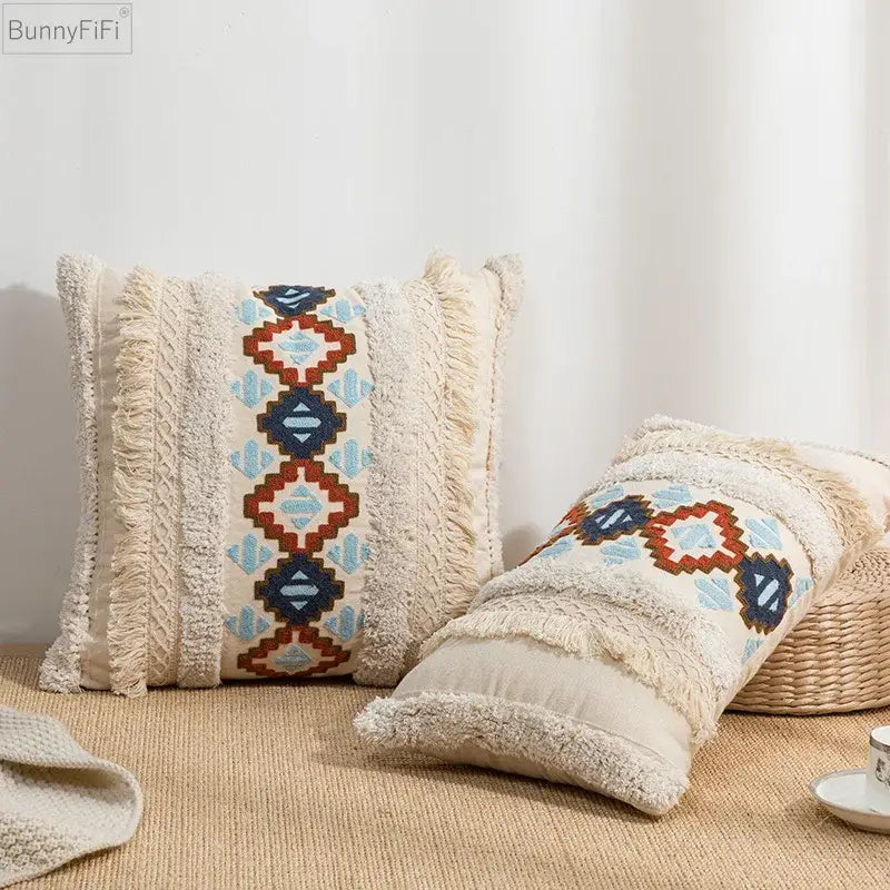 Cream-colored cushion cover with frayed edges and blue red geometric embroidered pattern for home decor by decorbites geometric embroidered