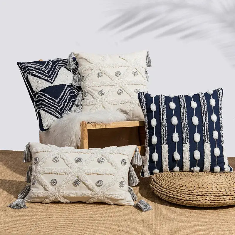 Cream-colored cushion cover with geometric embroidery and gray tufted tassels for decorbites bedroom decor