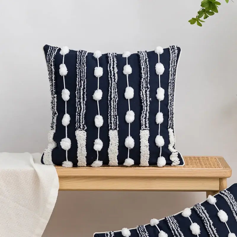 Navy blue geometric embroidered cushion cover with white textured stripes and tufted tassels for bedroom decorbites decor