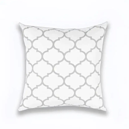 White throw pillow with repeating gray quatrefoil pattern in geometric embroidered light grey cotton cushion cover decorbites