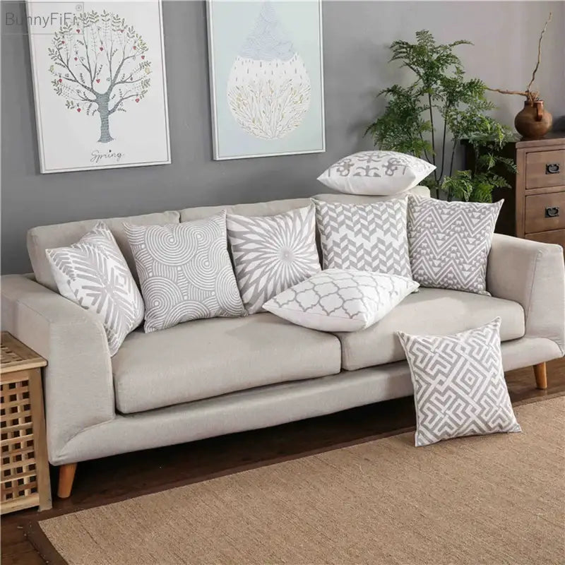 Beige upholstered sofa with decorbites geometric embroidered light grey cotton cushion cover for living room decor