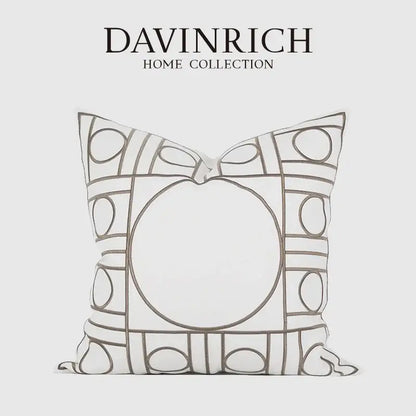 A white geometric embroidered noble cushion cover from davinrich home collection with gray outlined circles and rectangles