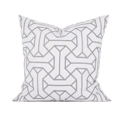 White throw pillow with intricate gray geometric embroidery in a repeating pattern from decorbites geometric embroidered cushion covers