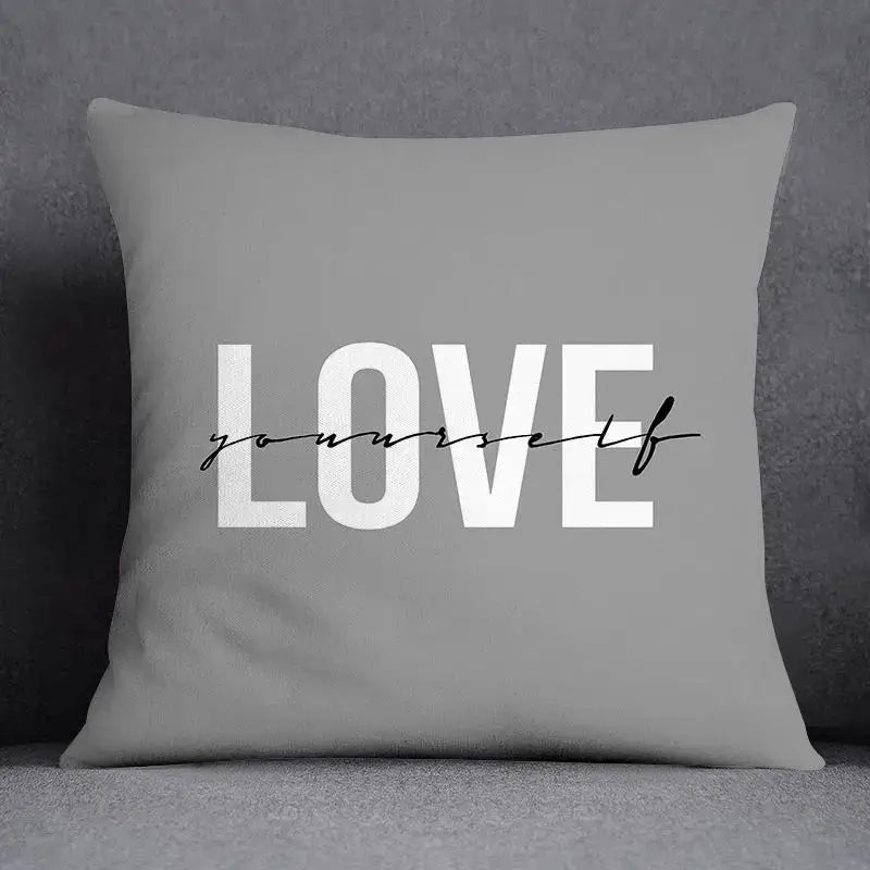 Gray square pillow case with love yourself print in white block and black cursive script for decorbites geometric floral print decor