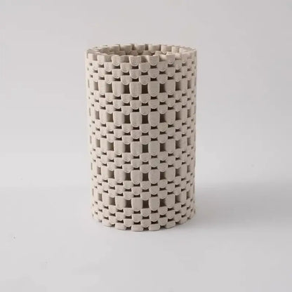 Beige ceramic cylindrical vase with a woven interlocking geometric folding pattern for living room decorbites decor