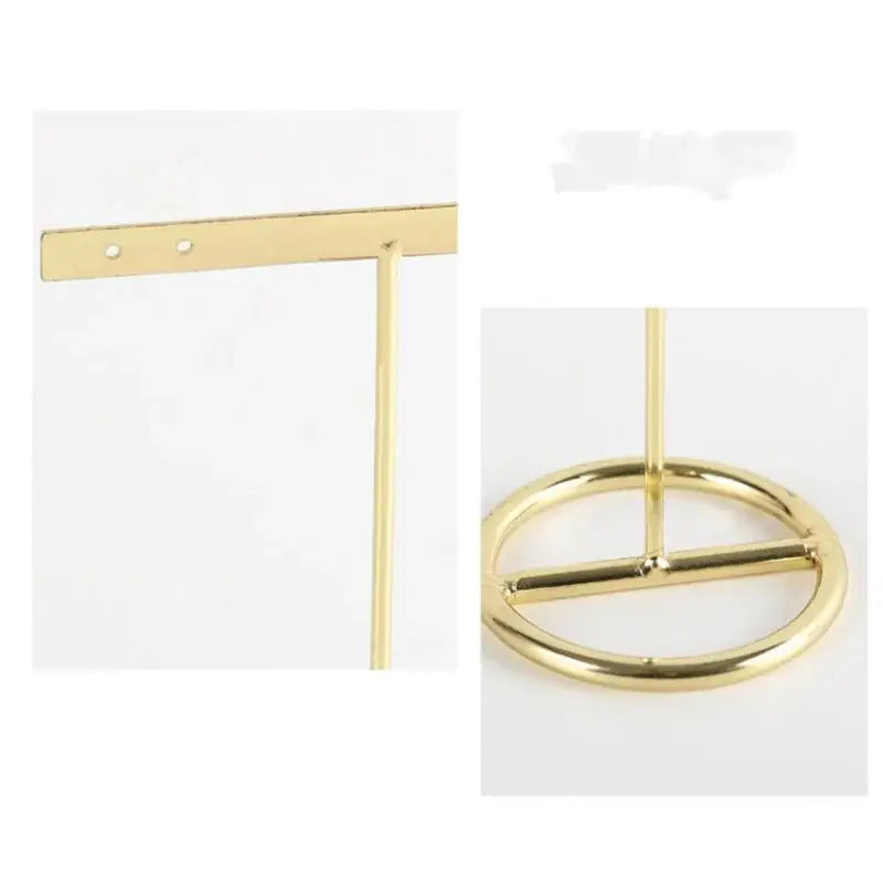 Gold-colored metal geometric jewelry display rack with circular base and horizontal bar for earrings in bedroom use