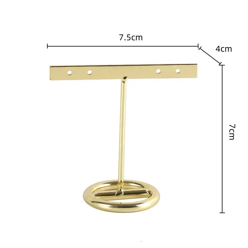 Geometric jewelry display gold metal earring stand with circular base and horizontal bar for bedroom use