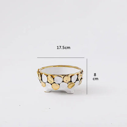 A white ceramic planter with geometric gold leaf relief and gold and silver circular embellishments for living room decor