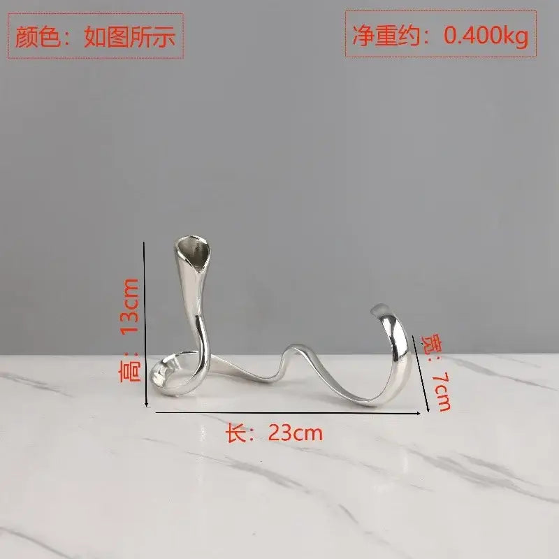 Silver metallic candlestick holder with sleek sculpted curves and open top for decorbites geometric gold dining centerpiece