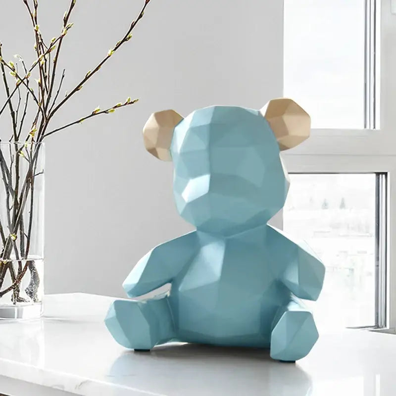 A light blue geometric bear figurine resin sculpture with gold ears on a white surface for living room decor