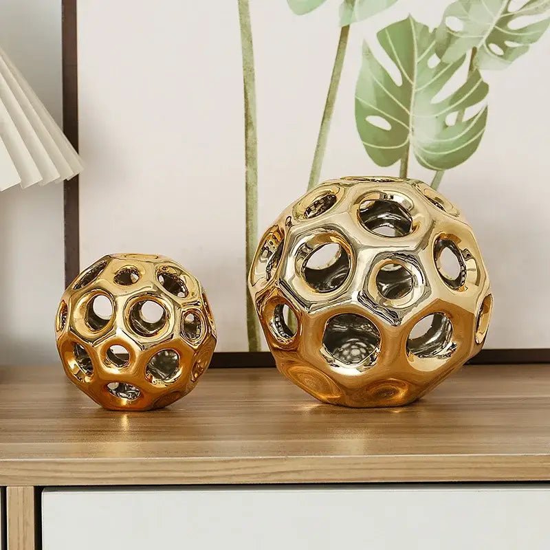 Golden hollow ceramic spheres with geometric perforated design for decorbites geometric golden hollow living room decor
