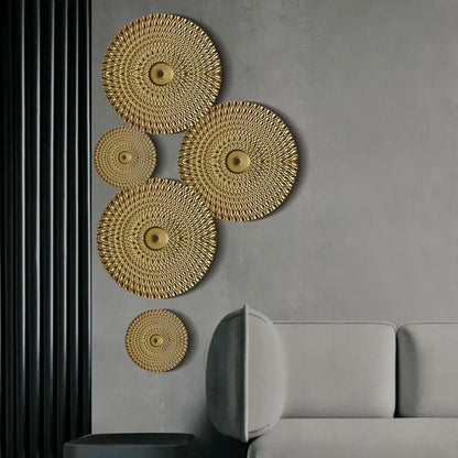 Geometric golden metal wall art featuring gold-colored circular design with textured diamond pattern and central embellishments