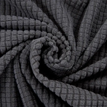 Dark gray corduroy sofa cover with a geometric waffle texture and pillow for living room stretch use