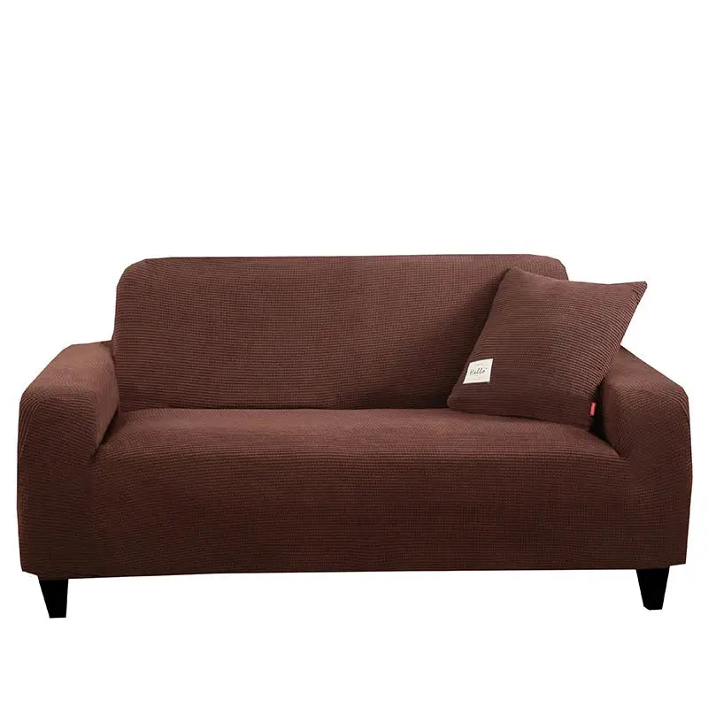 Brown textured stretch sofa cover with matching pillow for living room use featuring geometric gray design