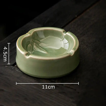 Delicate light green geometric green ceramic ashtray with subtle leaf design and four cigarette indentations for decorbites office desk decor