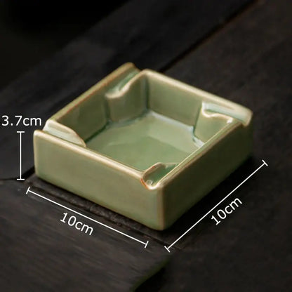 A geometric green ceramic ashtray with matte sage glaze and slightly raised rounded corners from decorbites for office desk decor