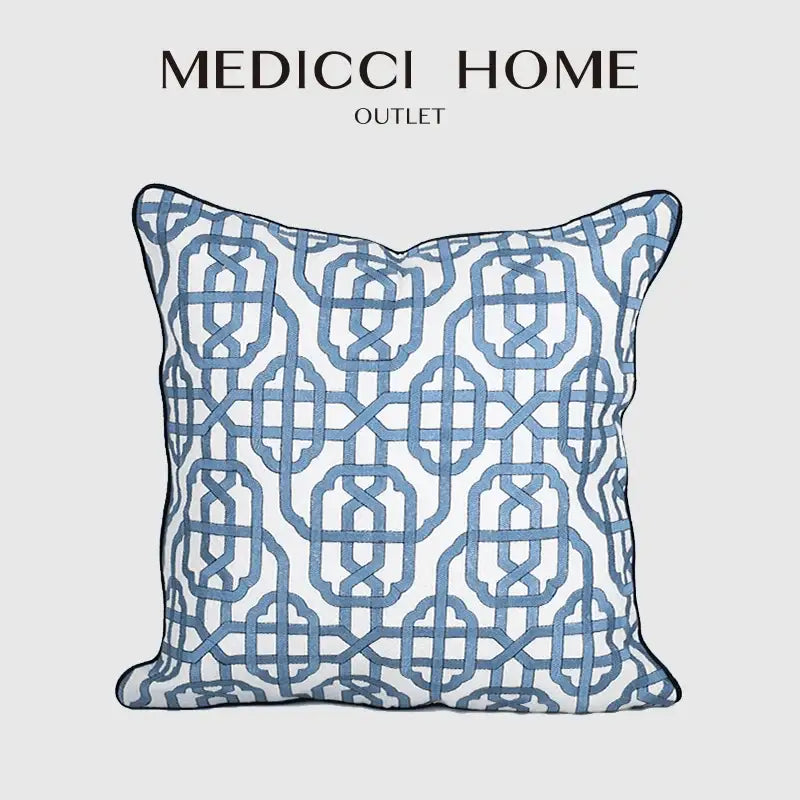 Blue geometric patterned pillow cover from Medicci Home Outlet featuring white embroidered details for living room decor