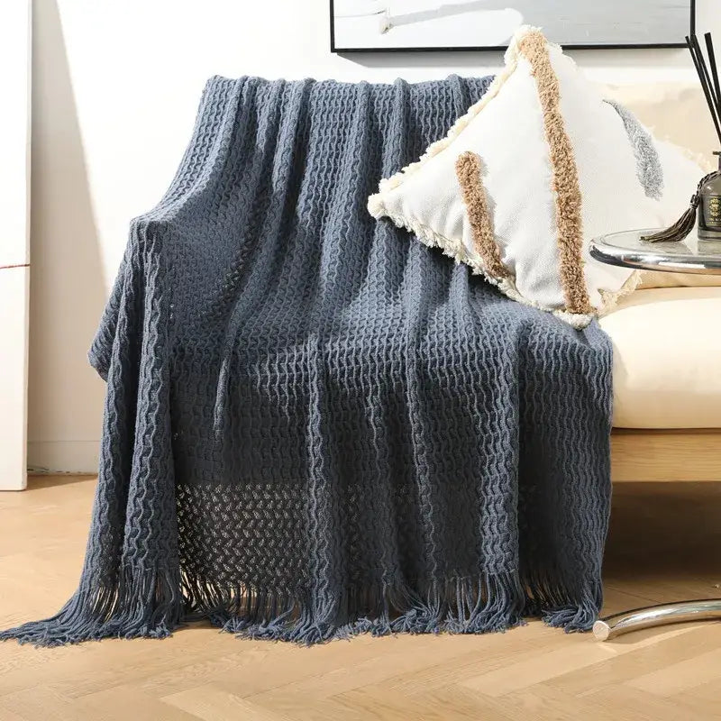 A cozy navy blue waffle pattern knit sofa blanket with fringed edges for decorbites geometric knit living room decor