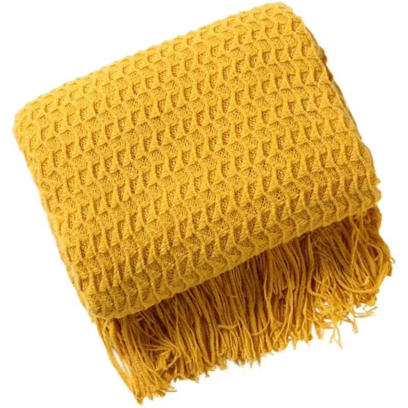 Cozy mustard-yellow decorbites geometric knit sofa blanket with textured diamond pattern and fringed tassel edges