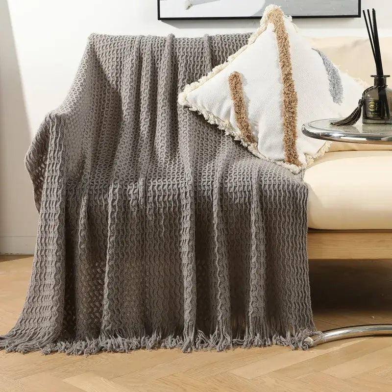 Gray textured knit sofa blanket with fringed edges and cozy woven pattern from decorbites geometric knit collection