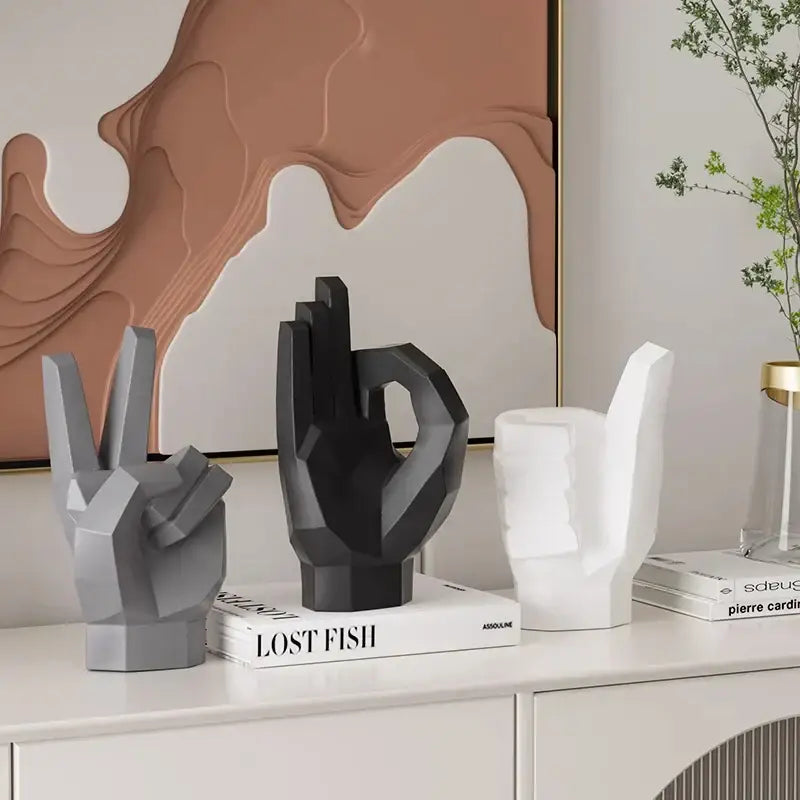 Black geometric hand sculpture with faceted matte gray design for modern gesture art decor living room set