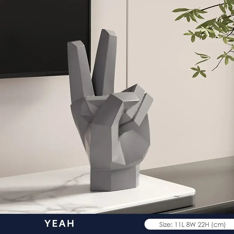 Gray geometric hand sculpture with peace sign gesture in matte resin for modern gesture art decor living room set