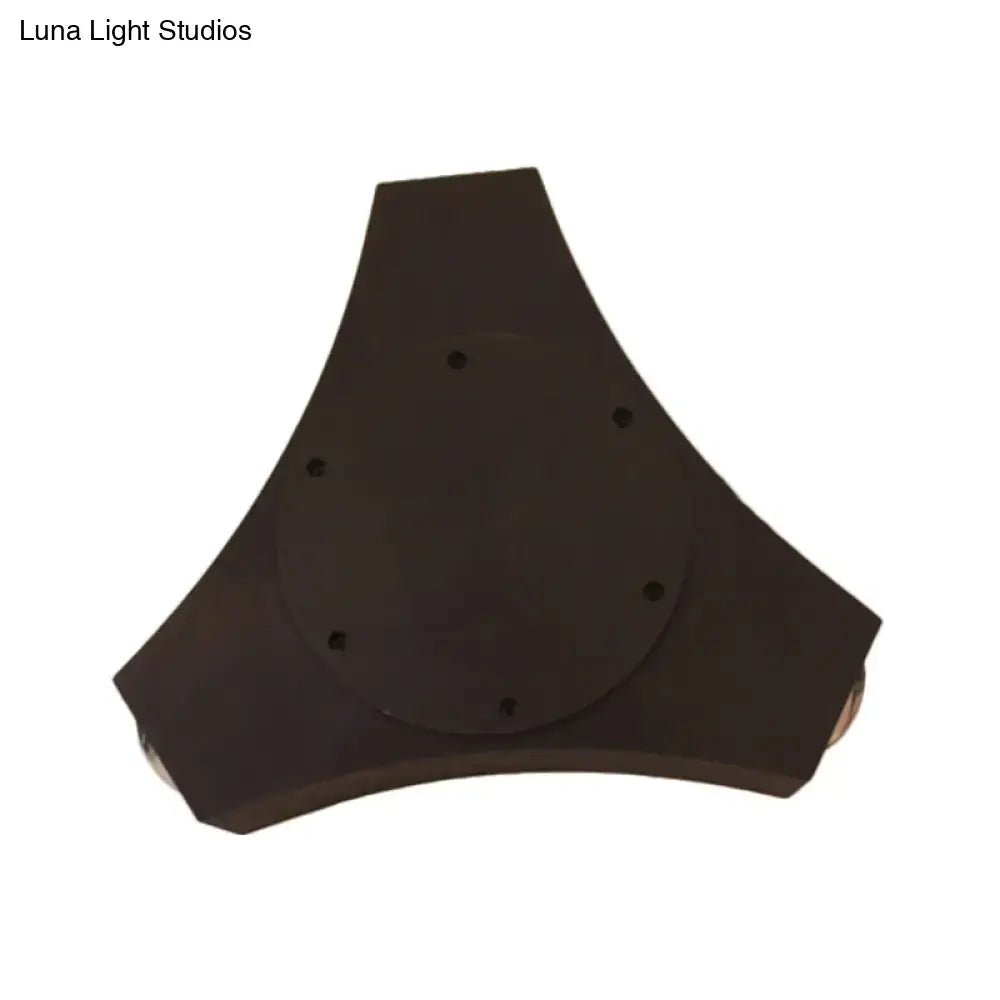 Black triangular-shaped camera tripod mount with circular plate and six holes on geometric metallic shade bronze wall sconce back side