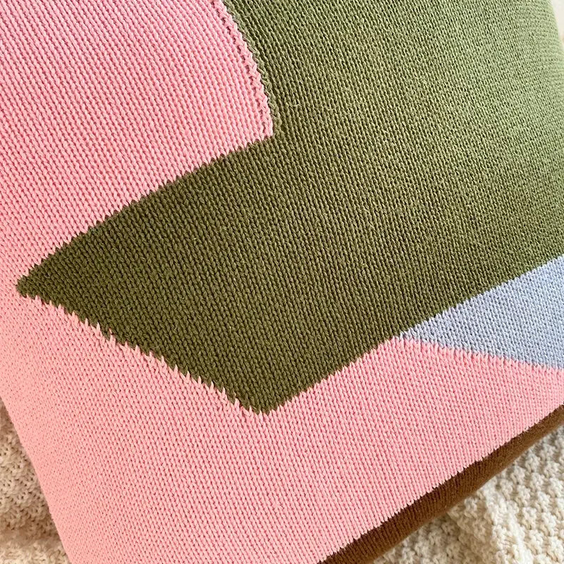 Cozy knitted cushion cover set with bold geometric pattern in soft pink olive green and light blue for living room decor