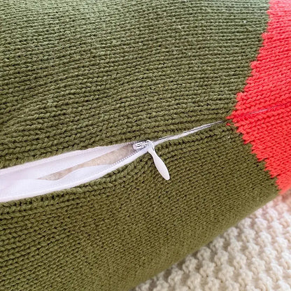 Olive green knitted cushion cover with coral red section and white zipper pull in geometric multi color cushion cover set
