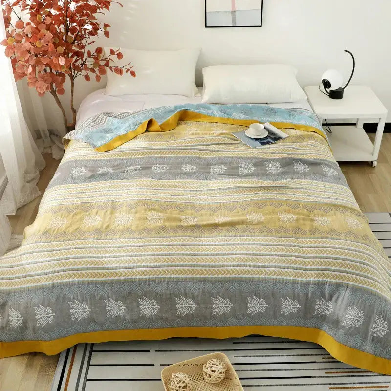 Geometric mustard and gray cotton gauze summer blanket with horizontal stripes and subtle botanical pattern decorbites cotton gauze