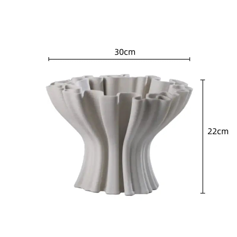 A sleek off-white ceramic flower pot sculpture with fluted organic ridges for living room decor