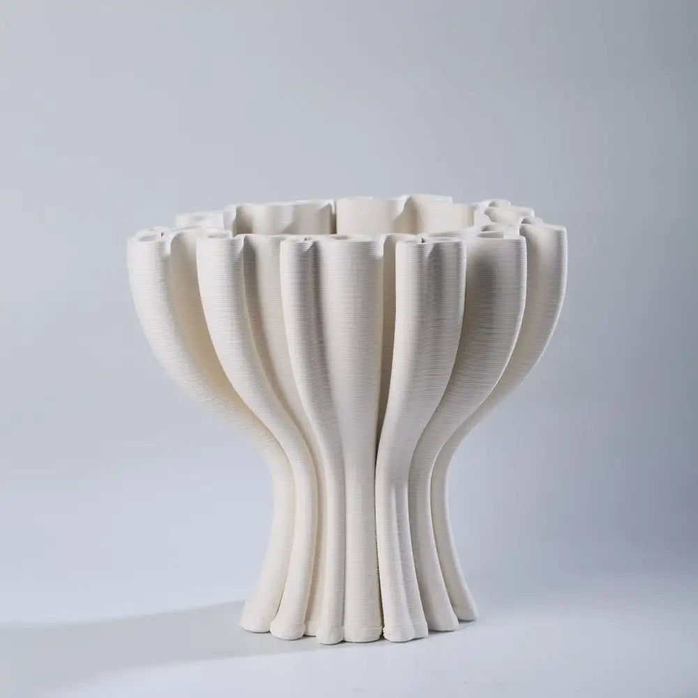 Cream-colored ceramic flower pot sculpture with a fluted design for geometric living room decor