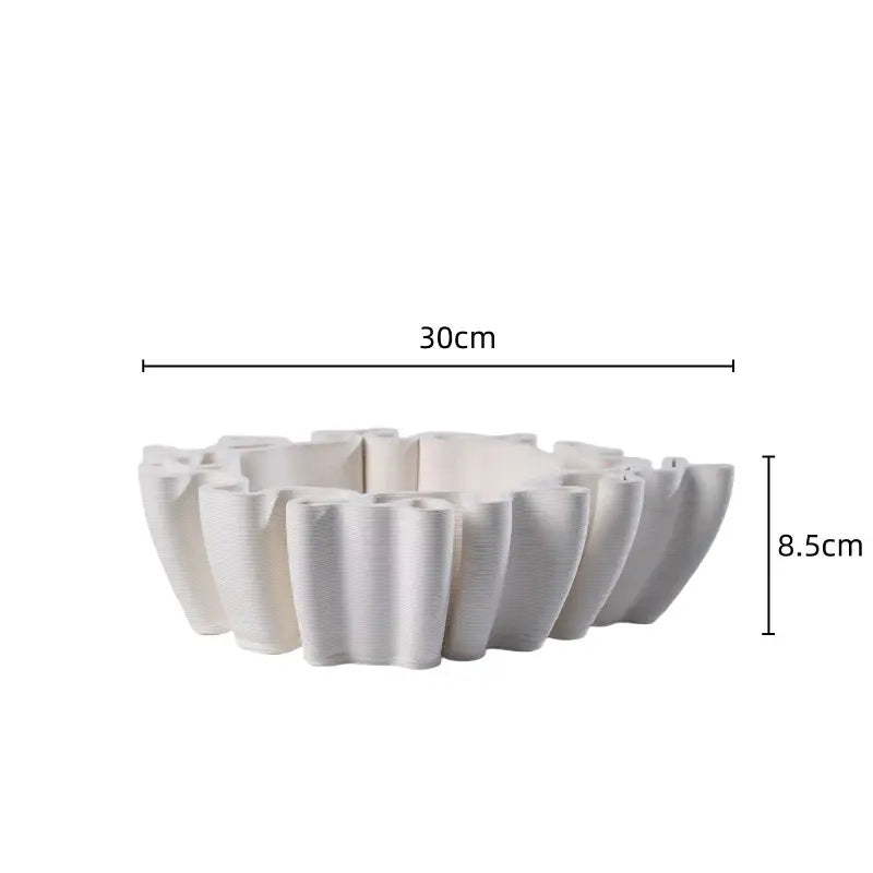 A white ceramic flower pot sculpture with a fluted petal rim and textured surface for living room decor