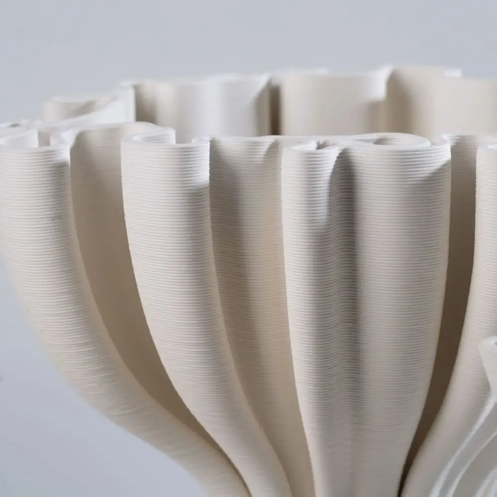 Cream-colored ceramic flower pot sculpture with a fluted ribbed design for living room decor