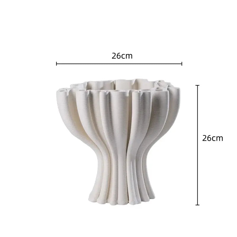 A white ceramic flower pot sculpture with fluted symmetrical ridges for living room decor