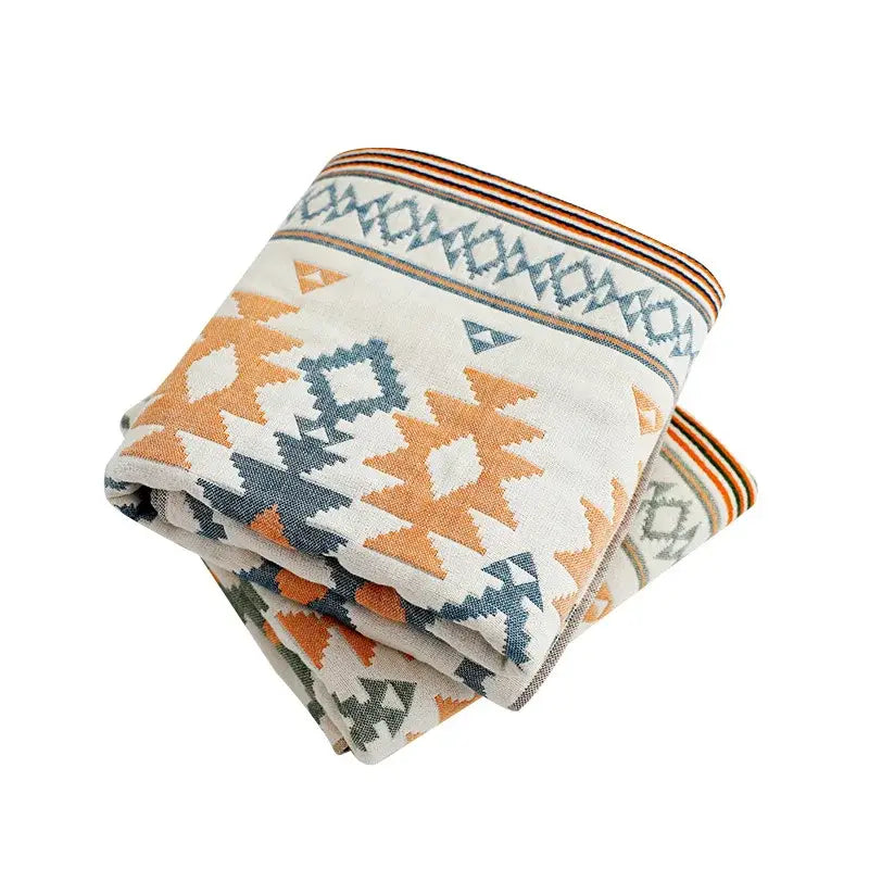 Folded bath towel with geometric orange and blue-gray pattern in decorbites cotton gauze for bathroom use