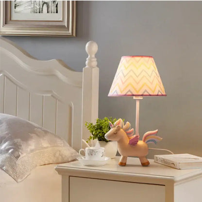 Pastel pink unicorn table lamp with colorful zigzag-patterned shade for children’s bedroom lighting