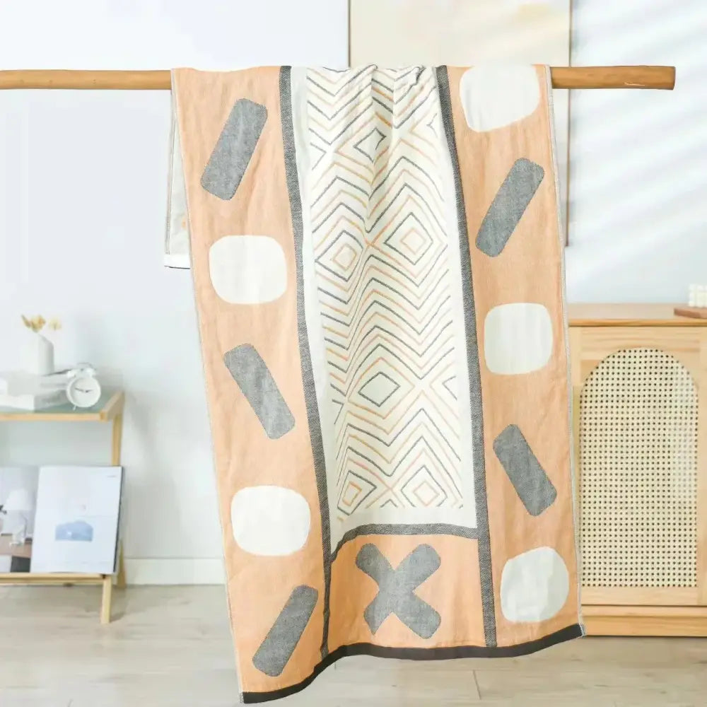 Beige and gray geometric-patterned cotton bath towel with central zigzag and oval shapes from decorbites cotton bath collection
