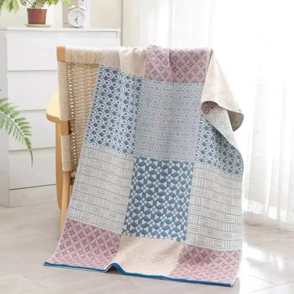 Soft patchwork-style decorbites cotton bath towel in muted pink gray and beige with geometric patterns for quick dry use