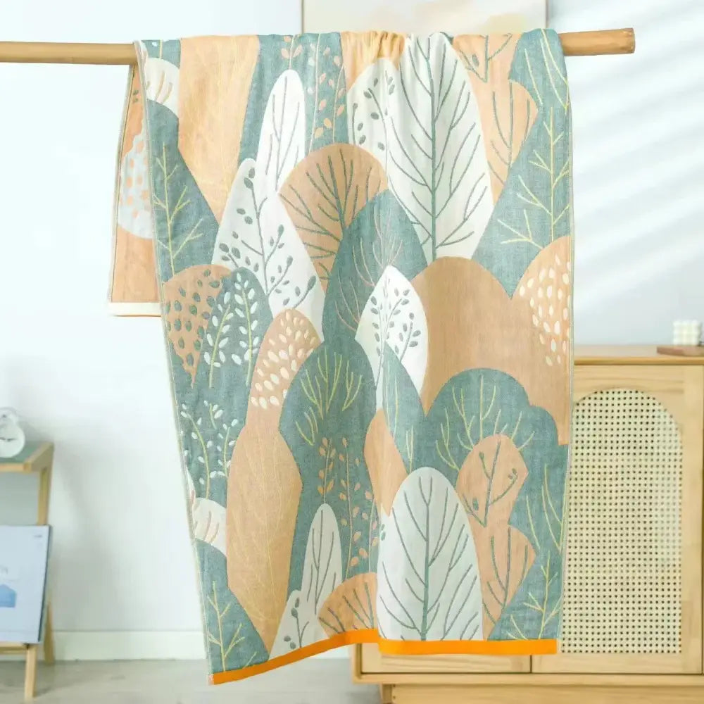 A decorbites cotton bath towel with modern botanical print in teal beige white and orange border quick dry accessory