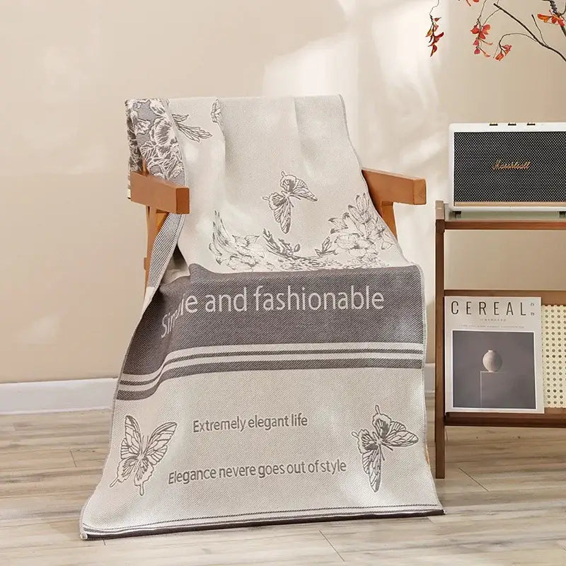 A soft off-white decorbites cotton bath towel with gray butterfly pattern and style and fashionable text for quick drying
