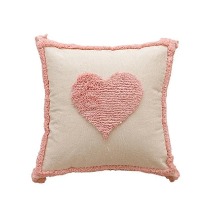 A cream cushion cover with a soft pink heart appliqué and frayed edges for decorbites geometric embroidered pillow covers